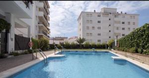 a large swimming pool in front of a building at Sitges Oasis in Sitges