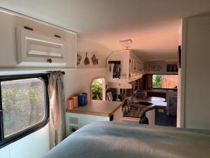 an rv kitchen with a sink and a stove at So Damn Lucky Glamping in Ucluelet