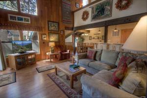 a living room with a couch and a tv at Bear Lake Hideaway condo in South Lake Tahoe