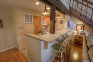 a kitchen with a counter and a bar with chairs at Bear Lake Hideaway condo in South Lake Tahoe