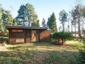 a small wooden cabin in a field with trees at 4 person holiday home in Nykøbing Sj-By Traum in Nyrup +41 photos