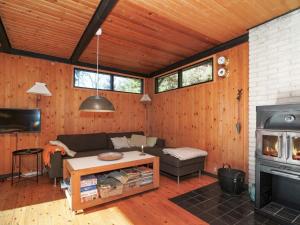 a living room with a couch and a fireplace at 4 person holiday home in Nykøbing Sj-By Traum in Nyrup