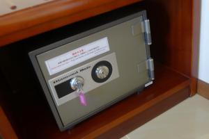 a safe with a pink ribbon attached to it at Seaside Hotel The Beach in Chatan