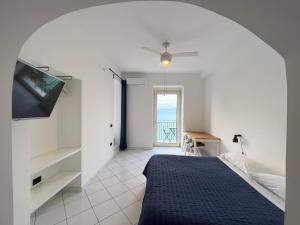 a bedroom with a bed and a view of the ocean at Borgo Dei Saraceni - Suites & Apartments in Agropoli
