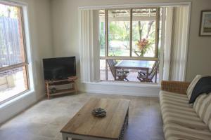a living room with a couch and a coffee table at 2 51 Carlo Road Rainbow Beach in Rainbow Beach