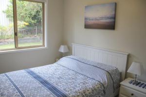 a bedroom with a bed and a window at 2 51 Carlo Road Rainbow Beach in Rainbow Beach