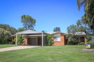 a brick house with awning in a yard at 2 51 Carlo Road Rainbow Beach in Rainbow Beach