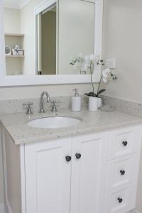 a bathroom counter with a sink and a mirror at 2 51 Carlo Road Rainbow Beach in Rainbow Beach