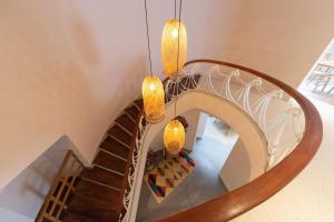 a spiral staircase with two chandeliers at Hostal Casa Mosaiko Nutibara Laureles in Medellín