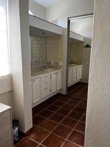 a bathroom with two sinks and two mirrors at FREE CAR W/ Private House & Ocean View in El Bedito