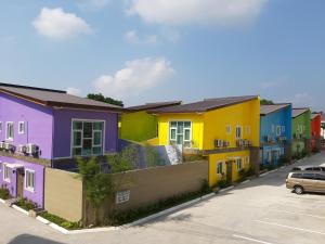 a row of colorful houses on a street at On Pool Villa in Fort Stotsenburg