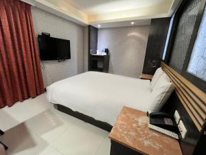 Giường trong phòng chung tại Guide Hotel Taipei Xinyi