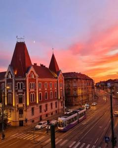 a city with a building and a bus on a street at No.8: Lovely & Cosy 3-room Heart of the City in Timişoara