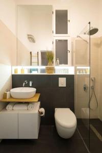 a bathroom with a sink and a toilet and a shower at No.8: Lovely & Cosy 3-room Heart of the City in Timişoara