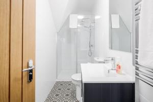 a bathroom with a sink and a toilet and a shower at Comfortable 2BR Apartment in Bedford in Bedford