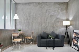 a living room with a couch and a table at The View Residence in Bangkok