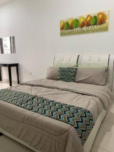1 cama en un dormitorio con una pintura en la pared en Elmina near Denai Alam, Saujana Utama with Wi-Fi & Netflix, en Shah Alam