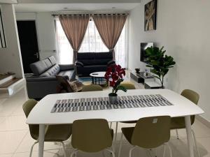 a white table and chairs in a living room at Elmina near Denai Alam, Saujana Utama with Wi-Fi & Netflix in Shah Alam