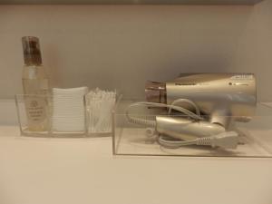 a kitchen appliance on a shelf with a bottle of wine at Kanazawa Sainoniwa Hotel in Kanazawa