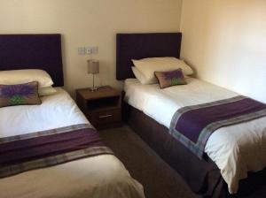 A bed or beds in a room at Glencarse Hotel