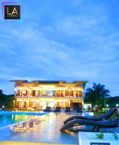 a large building with a pool in front of it at La Candura in Siquijor