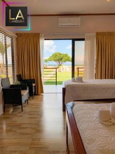 a hotel room with two beds and a view of the ocean at La Candura in Siquijor