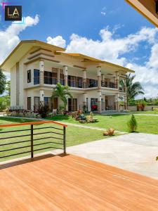 a large house with a fence in front of it at La Candura in Siquijor