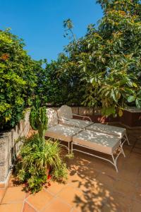 a table and a chair sitting on a patio at La Hacienda Grande in Puerto de la Cruz