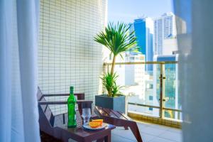 a table and chairs with a bottle on a balcony at Hotel Soco in Danang