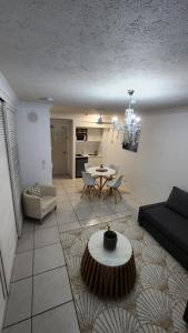 a living room with a couch and a table at 3 BLOCKS to SURFERS PARADISE BEACH in Gold Coast