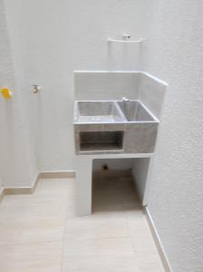 a bathroom with a sink in a white wall at Apartamento portal del prado in Santa Rosa de Cabal