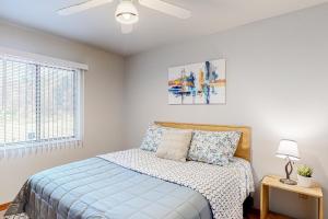 a bedroom with a bed and a ceiling fan at Speedway House in Port Orange