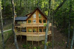 a house in the woods with a wrap around deck at Sky High Lodge - Blue Ridge in Blue Ridge