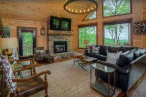 a living room with a couch and a fireplace at Sky High Lodge - Blue Ridge in Blue Ridge