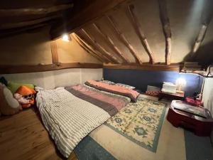 a bedroom with two beds and a rug at Mizuno Sang's Tree House 