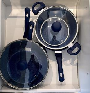 two pans on display in a glass case at Prima Tower Apartment Face to Crown by GoodLive in Melbourne