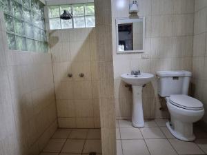a bathroom with a toilet and a sink at Bio-Cébaco Cabañas in Isla Cebaco  +36 photos