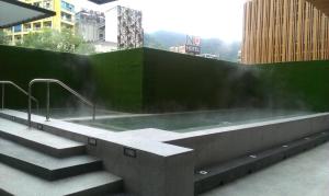 a hot tub in a building with stairs at Just Sleep Jiao Xi in Jiaoxi