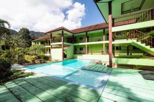 an exterior view of a building with a swimming pool at Aree Resort in Ban Bang Bao