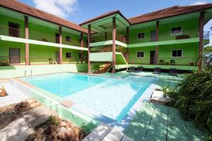 a large swimming pool in front of a building at Aree Resort in Ban Bang Bao
