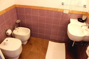 a bathroom with a toilet and a sink at Hotel O'scià in Lampedusa