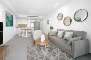 a living room with a couch and a table at CASSA SIGNATURE - Luxury Apartments Managed by The Cassa in Gold Coast