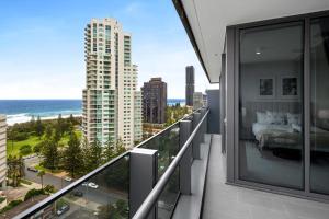 a balcony with a bed and a view of the ocean at CASSA SIGNATURE - Luxury Apartments Managed by The Cassa in Gold Coast