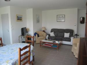 a living room with a couch and a table at Villa Saint-Cyprien, 4 pièces, 6 personnes - FR-1-106-40 in Saint-Cyprien