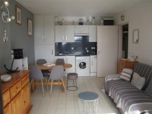 a kitchen and living room with a couch and a table at Appartement Saint-Cyprien, 3 pièces, 6 personnes - FR-1-106-44 in Saint-Cyprien