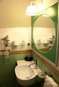 a bathroom with a sink and a mirror at Hotel O'scià in Lampedusa