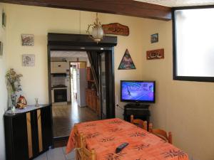 - une salle à manger avec une table et une télévision dans l'établissement Villa Saint-Cyprien, 3 pièces, 6 personnes - FR-1-106-57, à Saint-Cyprien