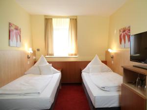 Postel nebo postele na pokoji v ubytování TOP Hotel Amberger