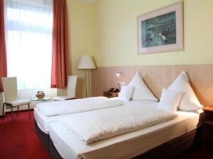 Postel nebo postele na pokoji v ubytování TOP Hotel Amberger