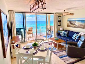 a living room with a couch and a table and chairs at Emerald Bay Escape in Panama City Beach